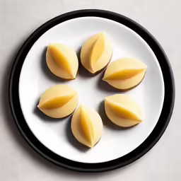 four pieces of potato cut up on a plate