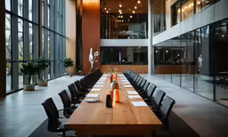 a long dining table with lots of chairs and bottles