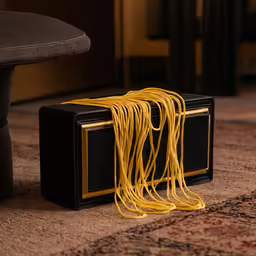 this is an old fashion television with long yellow cords tied to it
