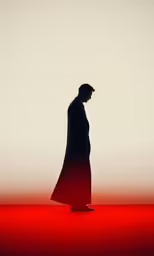 the man in the long coat is walking away
