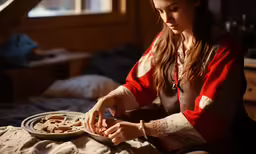 a woman that is sitting down with food