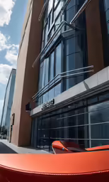 the front entrance to an office building with orange roof and glass windows