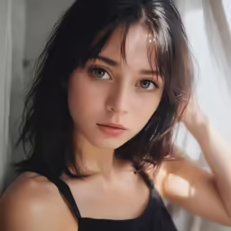 a very young woman posing for the camera