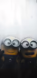 two minions sitting on top of each other with their eyes covered
