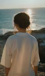 woman wearing a white top on top of a sandy beach
