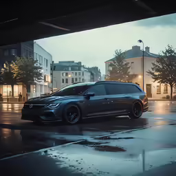a dark car is parked in the rain