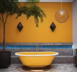 a bathroom that has a yellow bathtub and potted plant