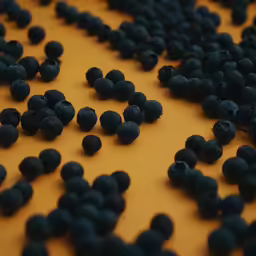 a pile of berries sitting on top of a yellow counter