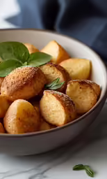 a bowl of bread with a leaf on top