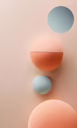 abstract shapes of two balls against a peach pink background