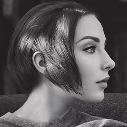 a black and white photo of a woman with bangs