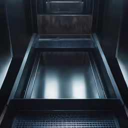an empty room with some metal bars and floor