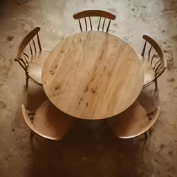 a wooden table with four chairs surrounding it