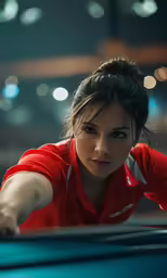 woman in red shirt leaning on the bumper of a blue car