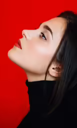 a woman with black hair wearing a black turtleneck