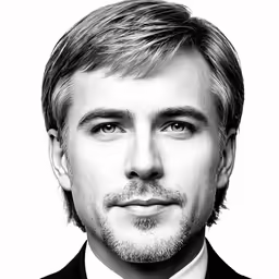 black and white photograph of man with blonde hair in suit