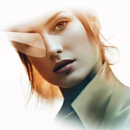the face of a woman, she is touching her nose