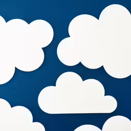 a close up of many different white clouds on a blue background