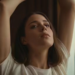 a woman is looking up in order to get her hair done