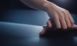 the hands are reaching toward something on the table