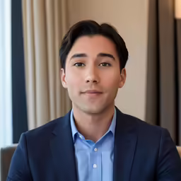 a man in a blue shirt is smiling for the camera