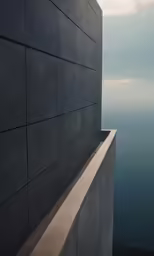a long grey wall overlooking the ocean