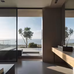 a modern bathroom has the doors open to reveal the ocean