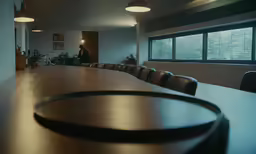 large long wooden table with chairs surrounding it