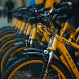 a close up of many yellow bikes parked together