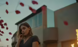 a woman talking on her cell phone while holding something