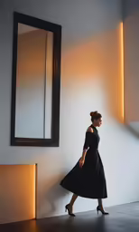 woman standing in front of mirror, looking down at herself