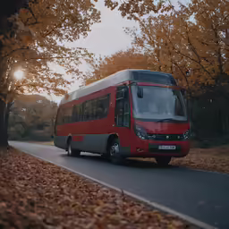 a bus driving down the street past a leaf filled forest