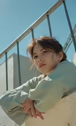 a woman is leaning against a railing