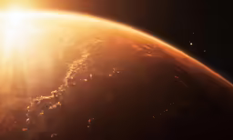 the sun shining over the earth from space