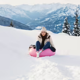a woman on top of a snowy hill
