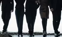 the woman with glasses is talking to two men