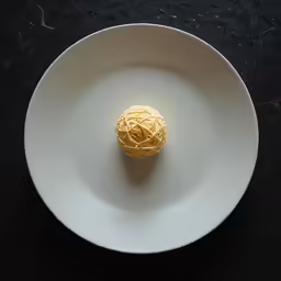 a piece of food sitting on top of a white plate