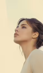 a woman with her eyes closed and wearing a white shirt