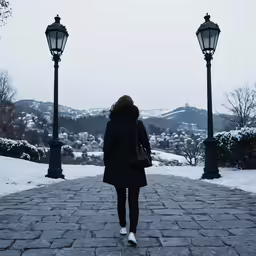 a woman is walking down a snowy walkway
