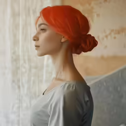 the lady is posing with her red hair in her hair