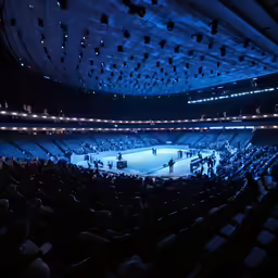 an indoor arena is shown at night in this photograph