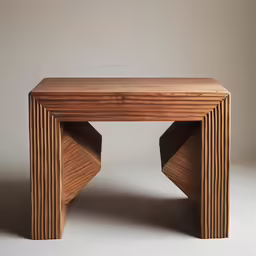 small table with stacked sections of wood sitting on a gray background