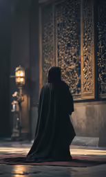 a man in a robe sitting on top of a floor