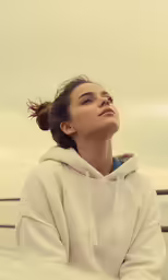 a young woman sitting on the side of a boat