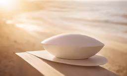 an empty white plate sits on the edge of a table