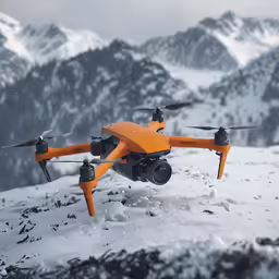 the orange unmanned flying over snow covered mountains
