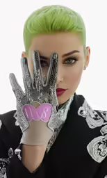 a person with green hair and gloves covering their face