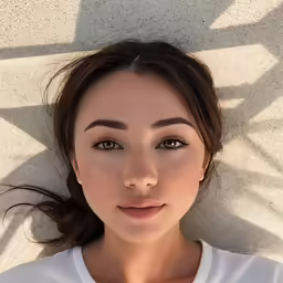 a female wearing a white shirt posing for the camera