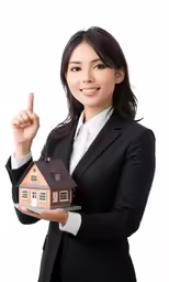 woman in business clothes holding up a small house