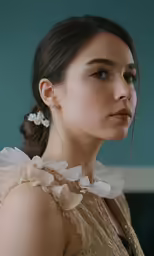 a woman wearing white pearls and a dress